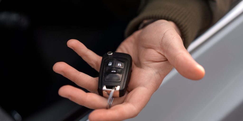 handing over the car remote spare key
